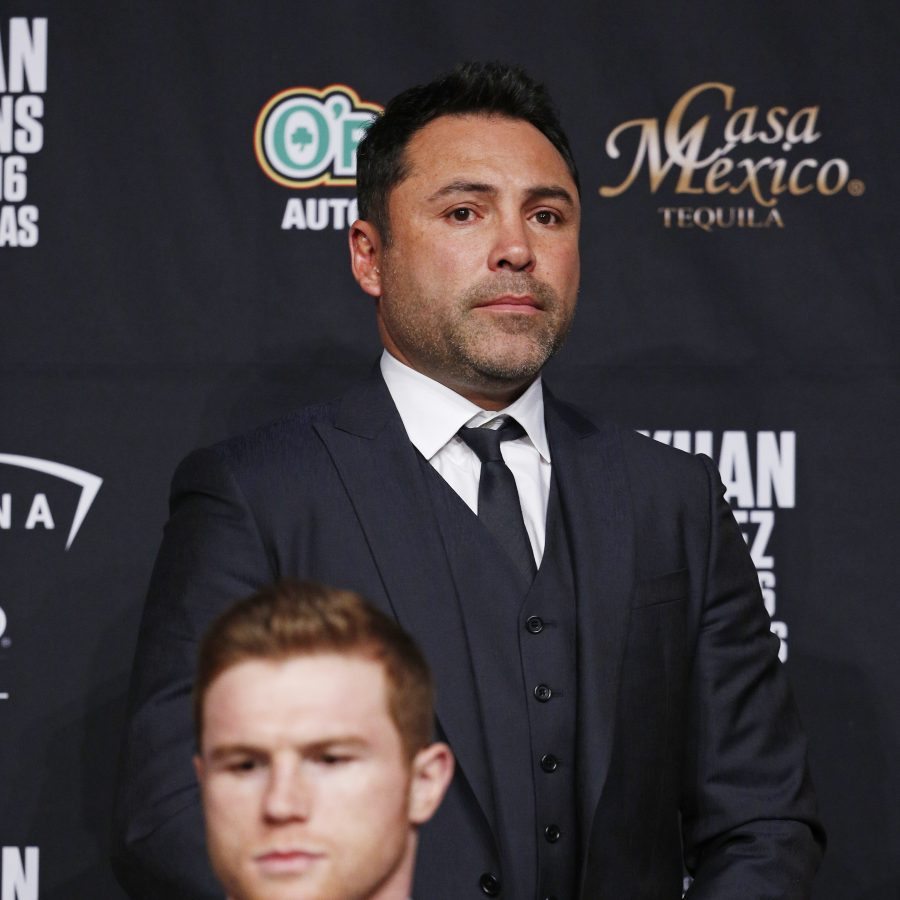 Canelo Alvarez, bottom left, attends a news conference with Oscar De La Hoya at the MGM Grand, Wednesday, May 4, 2016, in Las Vegas. Alvarez is scheduled to fight Amir Khan in a middleweight title bout Saturday in Las Vegas. (AP Photo/John Locher)