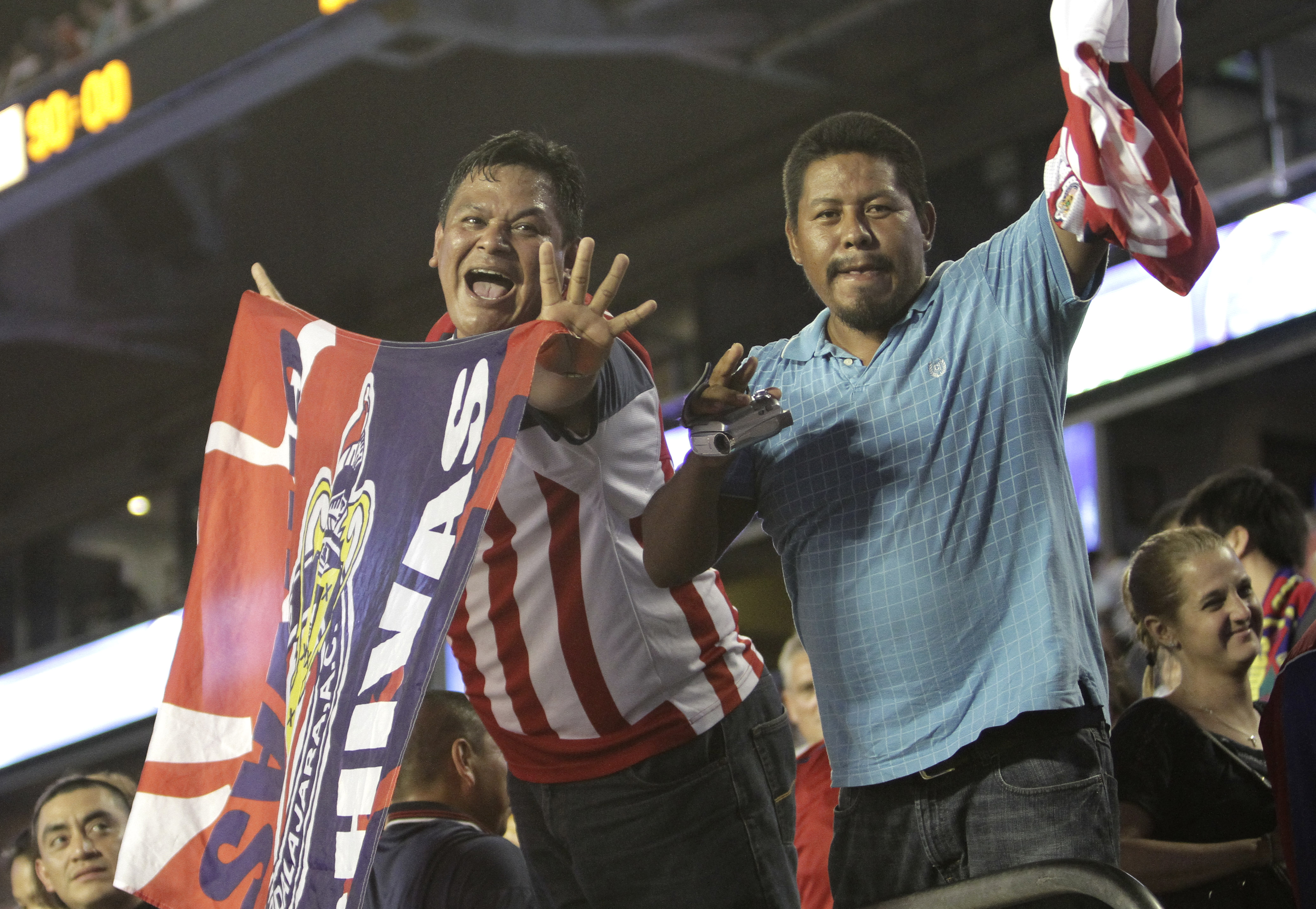 Mexico's los Chivas de Guadalajara fans celebrate after the Football Challenge Match soccer game against FC Barcelona in Miami, Wednesday, Aug. 3, 2011 against FC Barcelona. Guadalajara won 4-1. (AP Photo/J Pat Carter)