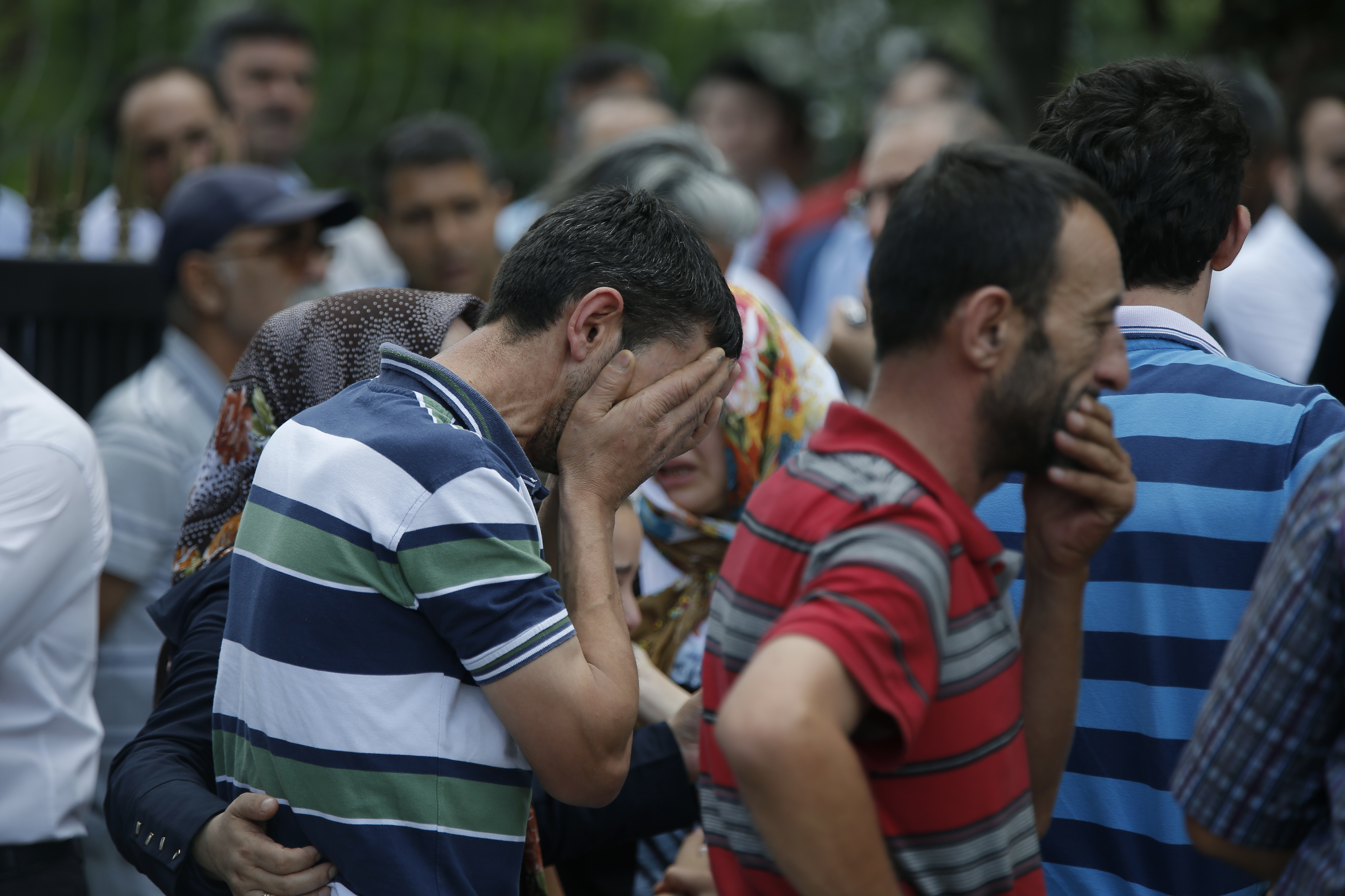 Family members of victims cry outside the Forensic Medical Center in Istanbul, Wednesday, June 29, 2016. Suicide attackers killed dozens and wounded more than 140 at Istanbul's busy Ataturk Airport late Tuesday, the latest in a series of bombings to strike Turkey in recent months. Turkish officials said the massacre was most likely the work of the Islamic State group. Turkish authorities have banned distribution of images relating to the Ataturk airport attack within Turkey.(AP Photo/Emrah Gurel) TURKEY OUT