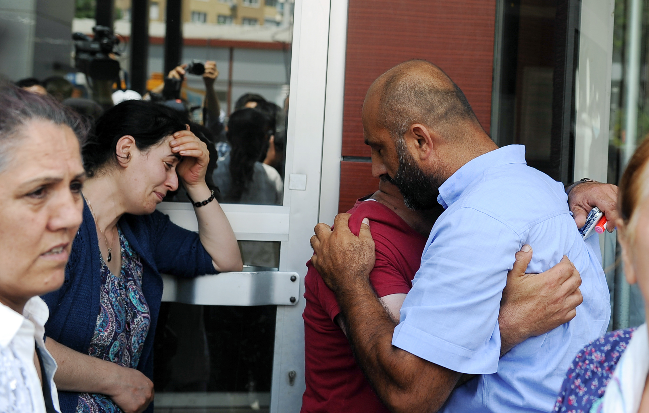 Family members of victims cry outside the Bakirkoy State Hospital in Istanbul, Wednesday, June 29, 2016. Suicide attackers killed dozens and wounded more than 140 at Istanbul's busy Ataturk Airport late Tuesday, the latest in a series of bombings to strike Turkey in recent months. Turkish officials said the massacre was most likely the work of the Islamic State group. Turkish authorities have banned distribution of images relating to the Ataturk airport attack within Turkey. (AP Photo/Omer Kuscu) TURKEY OUT