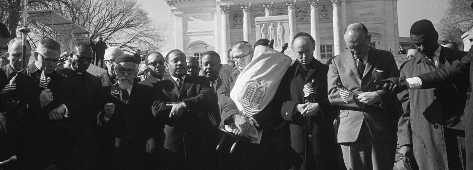 Leaders in a Vietnam war protest stand in silent prayer in Arlington National Cemetery, Feb. 6, 1968. Front row, from left: Rev. Andrew Young, executive vice president of the Southern Christian Leadership Conference; Bishop James P. Shannon, Roman Catholic auxiliary bishop of Minneapolis and St. Paul; Rabbi Abraham Heschel, professor at the Jewish Theological Seminary, New York; the Rev. Dr. Martin Luther King Jr., and Rabbi Maurice Eisendrath, president of the Union of American Hebrew Congregations. The Tomb of the Unknown Soldier and Arlington Amphitheater are in background. (AP Photo/Harvey Georges)