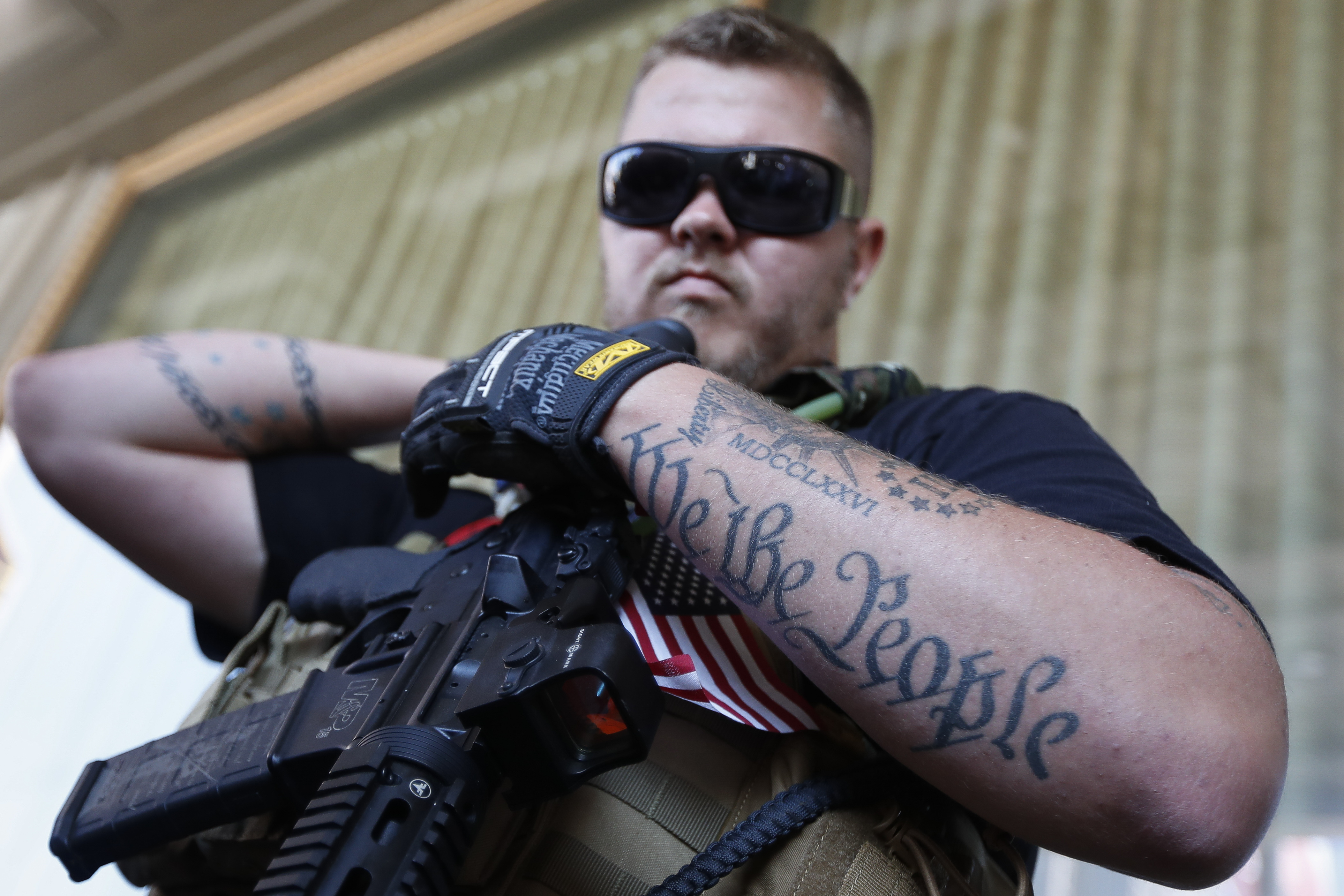 Trevor Leis, exercising his Ohio open carry rights, stands armed in Public Square on Tuesday, July 19, 2016, in Cleveland, during the second day of the Republican National Convention. (AP Photo/John Minchillo)