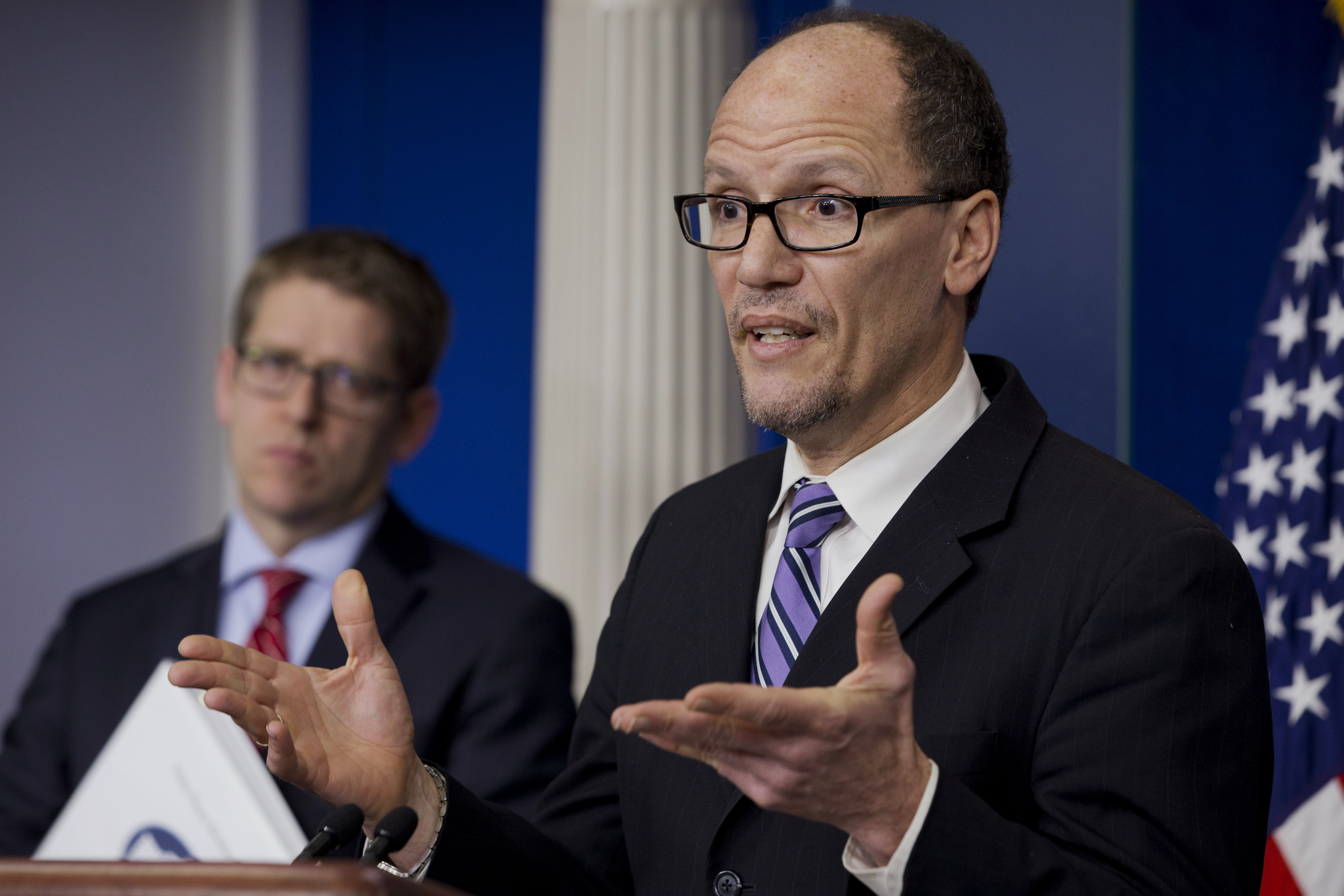 Labor Secretary Thomas Perez, right, accompanied by White House press secretary Jay Carney, speaks about the minimum wage increase for federal contract workers which will go into effect next year, Wednesday, Feb. 12, 2014, at the White House in Washington. (AP Photo/Jacquelyn Martin)
