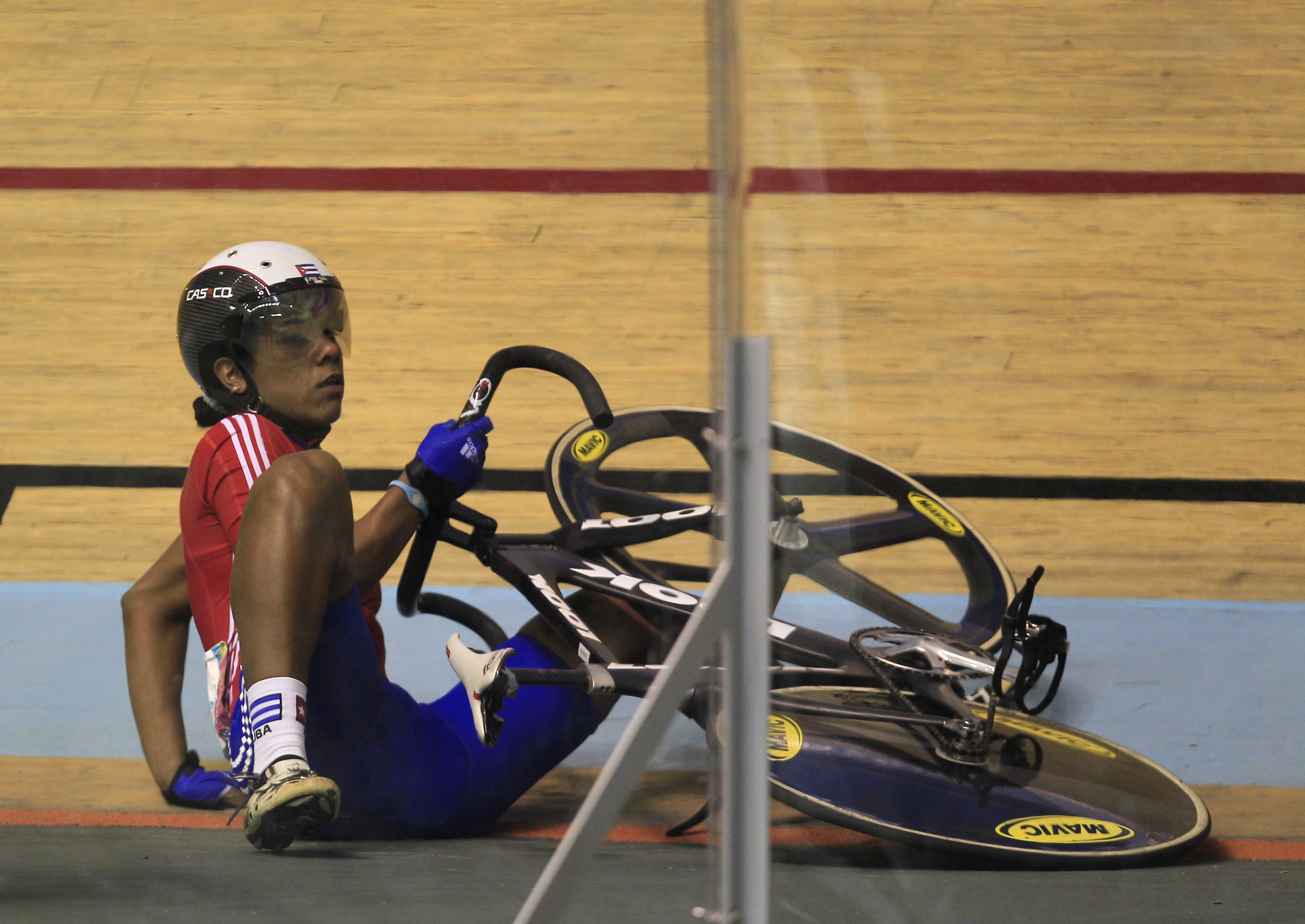 Cuba's Lisandra Guerra lies on the track after falling during the cycling women's keirin final at the Pan American Games in Guadalajara, Mexico, Thursday, Oct. 20, 2011. (AP Photo/Martin Mejia)