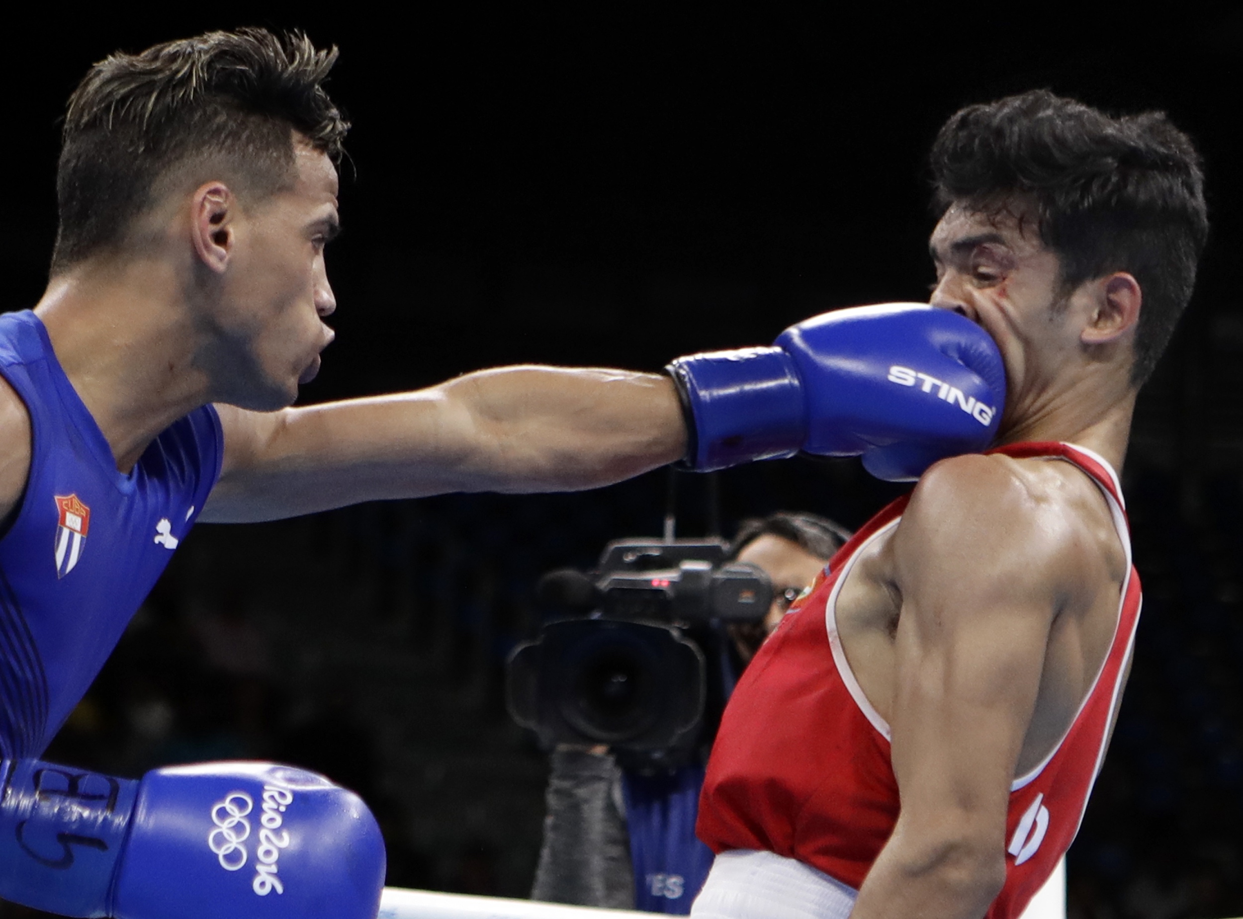 Cuba's Robeisy Ramirez, left, fights India's Shiva Thapa during a men's bantamweight 56-kg preliminary boxing match at the 2016 Summer Olympics in Rio de Janeiro, Brazil, Thursday, Aug. 11, 2016. (AP Photo/Frank Franklin II)