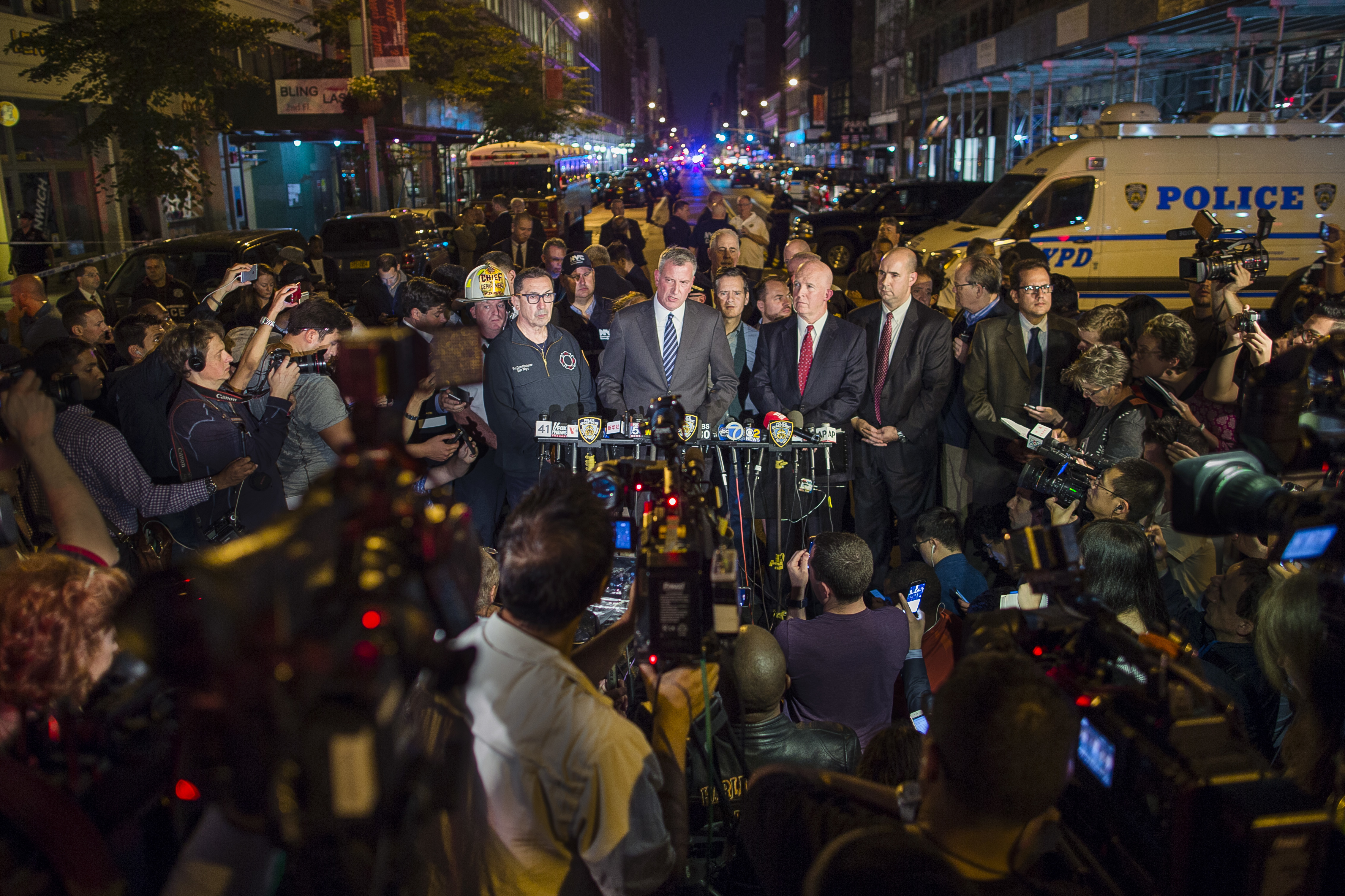 Mayor Bill de Blasio, center, and NYPD Chief of Department James O'Neill, center right, speak during a press conference near the scene of an apparent explosion on West 23rd street in Manhattan's Chelsea neighborhood, in New York, Saturday, Sept. 17, 2016. Police say more than two dozen people were injured in the explosion Saturday night. (AP Photo/Andres Kudacki)