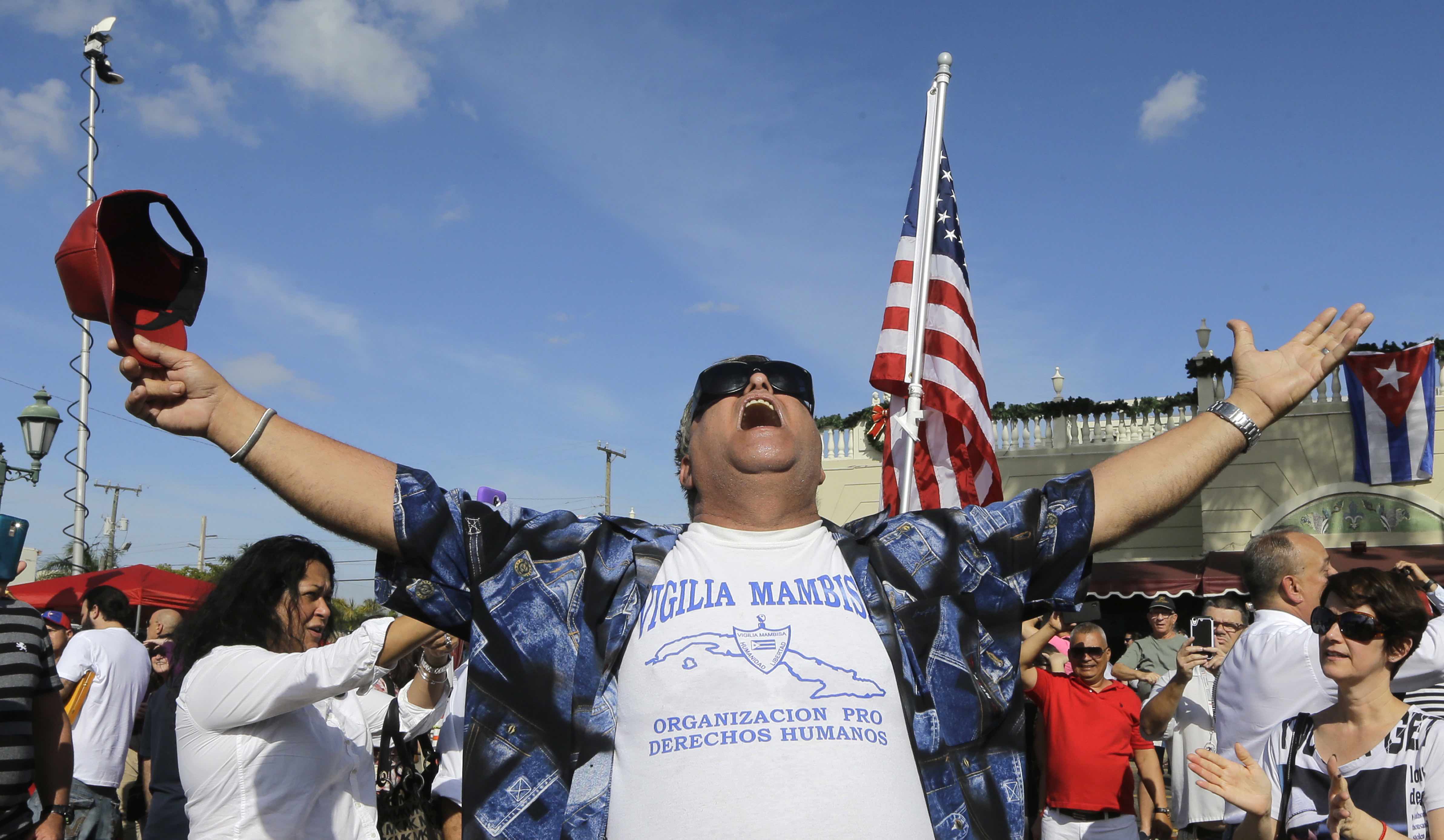 A members of the Cuban community reacts to the death of Fidel Castro, Saturday, Nov. 26, 2016, in the Little Havana area in Miami. Castro, who led a rebel army to improbable victory in Cuba, embraced Soviet-style communism and defied the power of 10 U.S. presidents during his half century rule, died at age 90. (AP Photo/Alan Diaz)